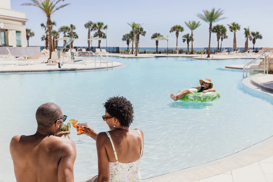 Pool deck at an Embassy Suites resort, photographed for Hilton